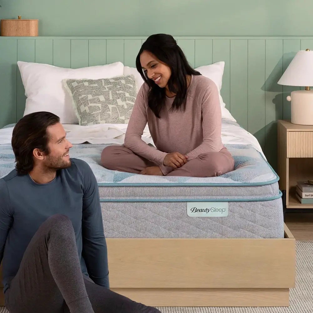 Couple looking at each other by a Beautyrest Sleep mattress