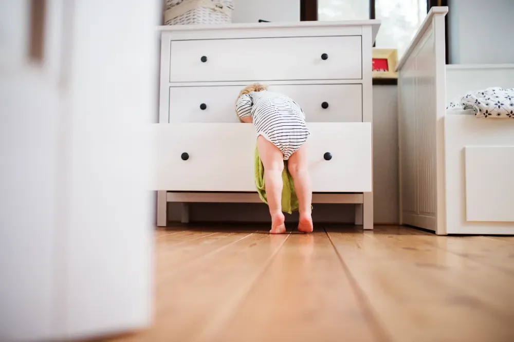 Toddler looking through a drawer